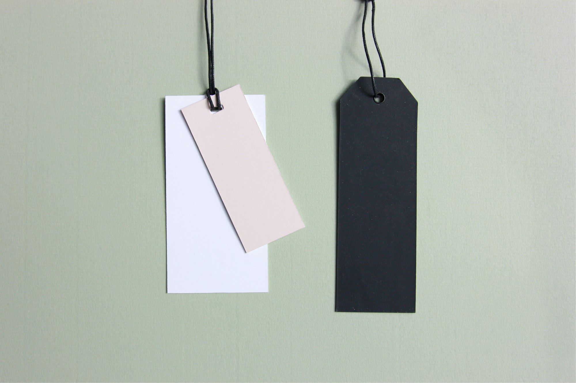 Three coloured price tags on a hook